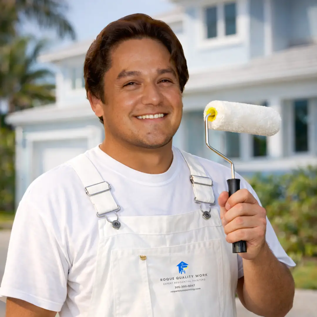 Isaias Roque house painting wearing overall and holding paint roller offering house paint servoces in Miami